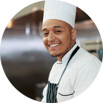 smiling chef wearing a chef's hat